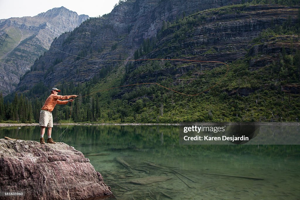 Mature man fly fishing, Glacier National Park