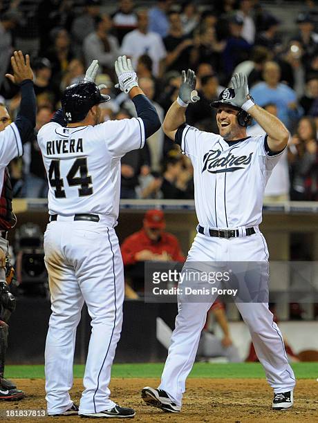 Chris Robinson of the San Diego Padres is congratulated by Rene Rivera of the San Diego Padres after he hit a three-run homer during the eighth...