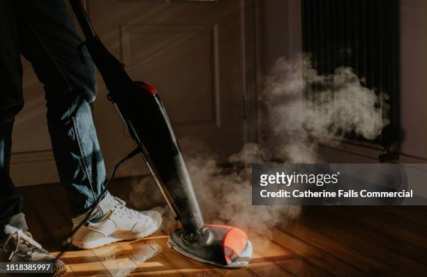 a person mops the floor using an electric steam mop - maid hoovering stock pictures, royalty-free photos & images