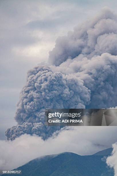 Volcanic ash spews from Mount Marapi during an eruption as seen from Tanah Datar in West Sumatra on December 3, 2023. A volcano in western Indonesia...