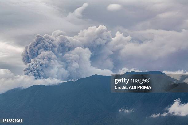 Volcanic ash spews from Mount Marapi during an eruption as seen from Tanah Datar in West Sumatra on December 3, 2023. A volcano in western Indonesia...