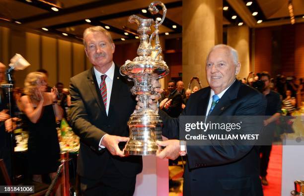 Australia II skipper John Bertrand and owner Alan Bond present a replica of the America's Cup they won at a luncheon to celebrate the 30th...