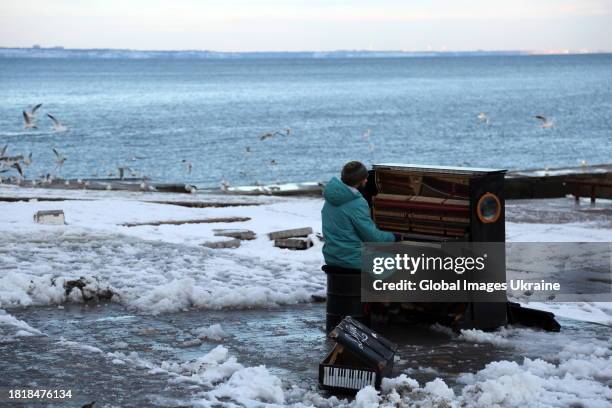 Musician Ihor Yanchuk plays the piano on the snowy Lanzheron beach on November 27, 2023 in Odesa, Ukraine. On November 26, an anticyclone came to...