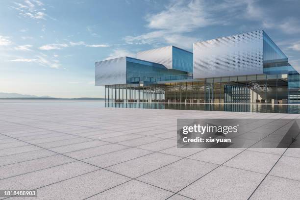 empty square front of modern architecture with silver metallic panels by pool - zementboden stock-fotos und bilder