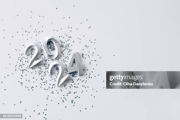 silver numbers 2024 with star shape glitter on a white background. flat lay. minimalistic - star confetti white background stockfoto's en -beelden