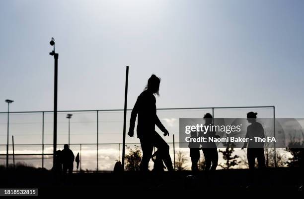 Players are silhouetted during a training session at St George's Park on November 28, 2023 in Burton upon Trent, England.