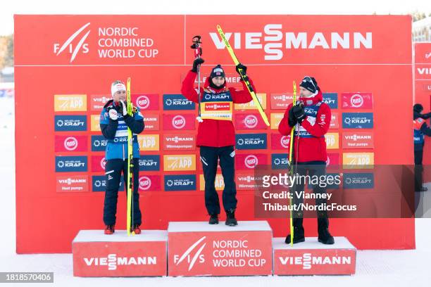 Johannes Lamparter of Austria takes second place, Jarl Magnus Riiber of Norway takes first place, Joergen Graabak of Norway takes third place during...