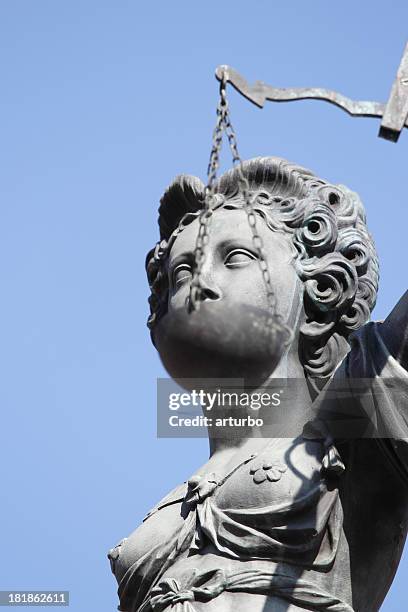 blind eyes ancient lady justice justitia against perfect blue sky - lady justice stockfoto's en -beelden