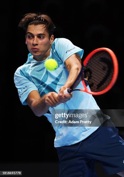 Fabio Cobolli of Italy hits a backhand to Dominic Stricker of Switzerland during their first round robin match on day one of the Next Gen ATP Finals...