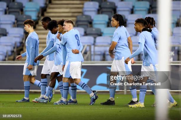 Josh Adam of Manchester City celebrates with team mates after scoring their sides second goal during the UEFA Youth League 2023/24 match between...