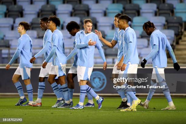 Josh Adam of Manchester City celebrates with team mates after scoring their sides second goal during the UEFA Youth League 2023/24 match between...