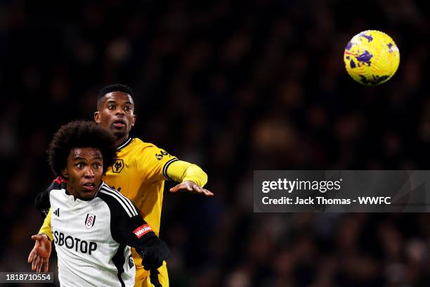 Willian of Fulham FC is challenged by Nelson Semedo of Wolverhampton Wanderers during the Premier League match between Fulham FC and Wolverhampton...