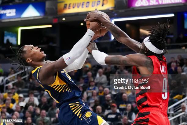 Bennedict Mathurin of the Indiana Pacers and Jerami Grant of the Portland Trail Blazers battle for the ball in the fourth quarter at Gainbridge...