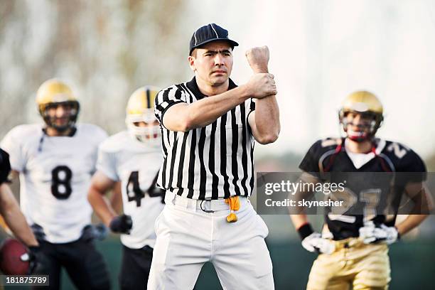 referee: illegal use of hands. - american football referee stockfoto's en -beelden