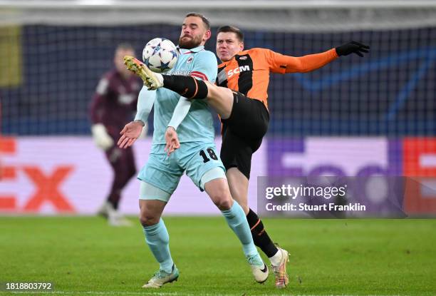 Vincent Janssen of Royal Antwerp is challenged by Mykola Matviyenko of FC Shakhtar Donetsk during the UEFA Champions League match between Shakhtar...