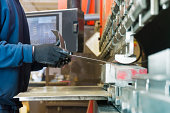 Brake press operator at work in a metal factory