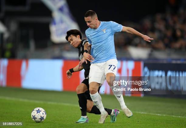 Adam Marusic of SS Lazio is challenged by Yang Hyun-Jun of Celtic during the UEFA Champions League match between SS Lazio and Celtic FC at Stadio...