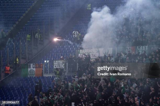 The Celtic FC supporters throw a smoke bomb during the UEFA Champions League match between SS Lazio and Celtic FC at Stadio Olimpico on November 28,...