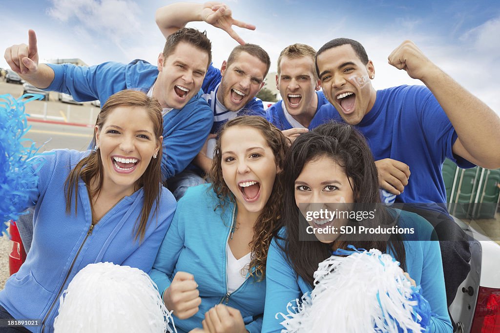 Group of cheering sports fan tailgating at stadium