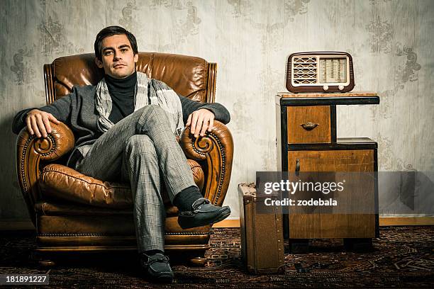 elegant retro man sitting in vintage room - 1970s model stock pictures, royalty-free photos & images