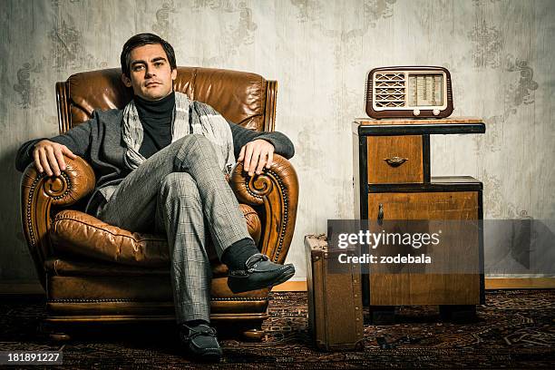 elegant retro man sitting in vintage room - retro radio stock pictures, royalty-free photos & images