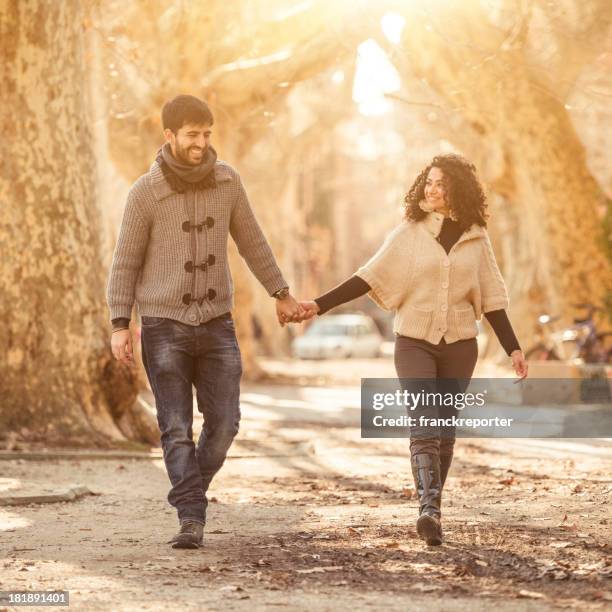 couple walking outdoors holding hands - european best pictures of the day february 14 2013 stock pictures, royalty-free photos & images