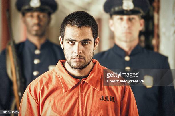 portrait of young criminal in prison - prison uniform stock pictures, royalty-free photos & images