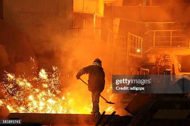 man is working in the splashing molten iron - metallurgical industry stock pictures, royalty-free photos & images