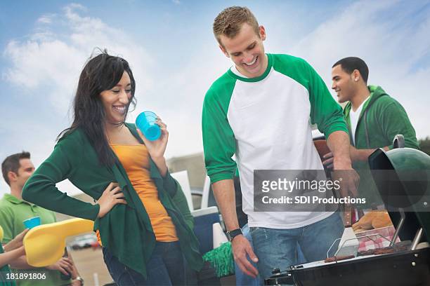 group of college friends tailgating before football game - university student picnic stock pictures, royalty-free photos & images