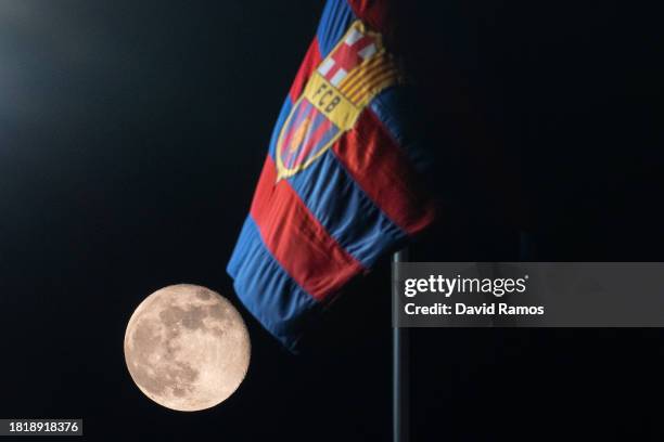 View of the moon alongside an FC Barcelona flag ahead of the UEFA Champions League match between FC Barcelona and FC Porto at Estadi Olimpic Lluis...