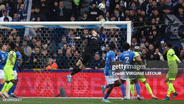 Genk's goalkeeper Maarten Vandevoordt jumps to hit the ball during the Belgian Pro League football match between KRC Genk and KAA Gent in Genk on...