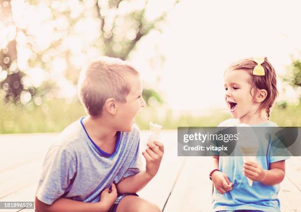 young boy and girl enjoying ice cream on a summer day - family ice nature stock pictures, royalty-free photos & images