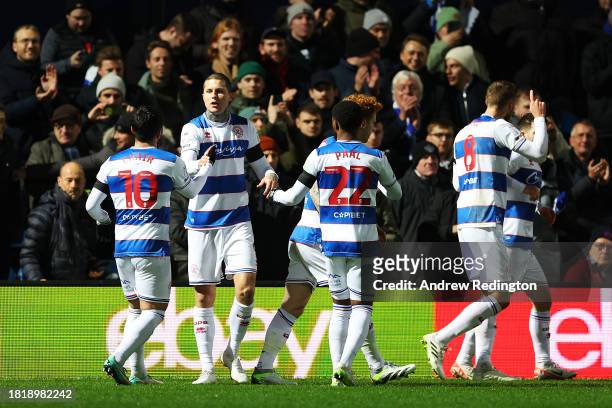 Lyndon Dykes of Queens Park Rangers celebrates with teammates after scoring the team's first goal during the Sky Bet Championship match between...