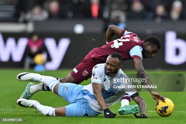 Crystal Palace's French-born Ghanaian striker Jordan Ayew vies with West Ham United's Ghanaian midfielder Mohammad Kudas during the English Premier...