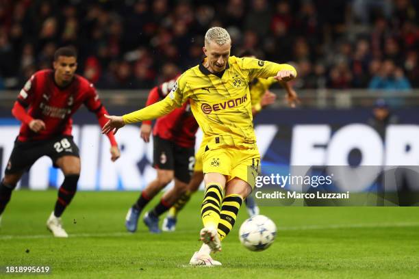 Marco Reus of Borussia Dortmund scores the team's first goal from a penalty kick during the UEFA Champions League match between AC Milan and Borussia...