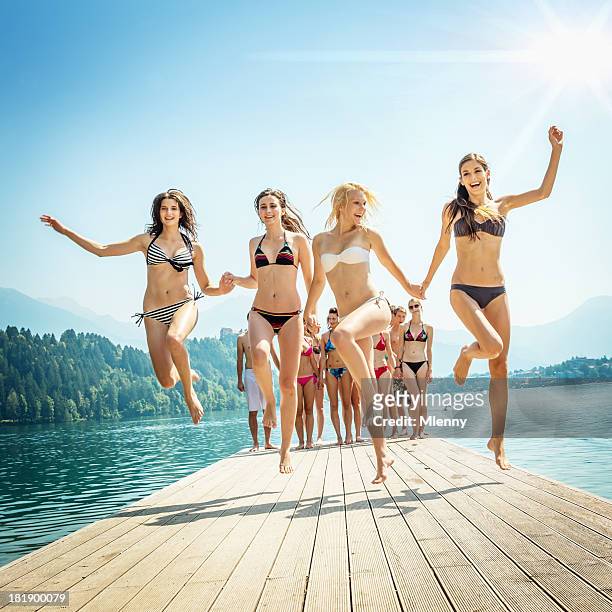 beach girls cheering on jetty - pretty girls in swimsuits bildbanksfoton och bilder
