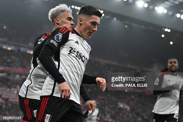 Fulham's Welsh midfielder Harry Wilson celebrates with Fulham's English-born US defender Antonee Robinson after scoring their first goal during the...