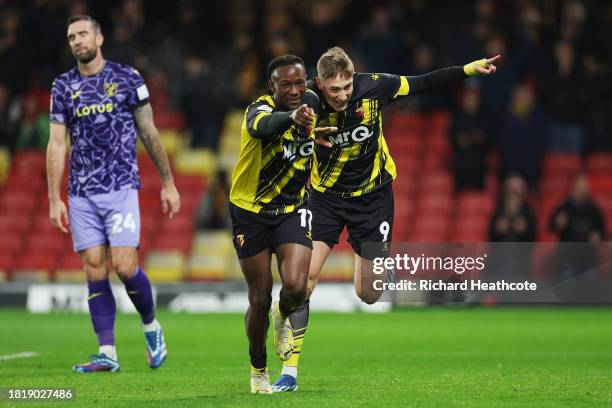 Mileta Rajovic of Watford celebrates with teammate Ismael Kone after scoring the team's second goal in front of a dejected Shane Duffy of Norwich...