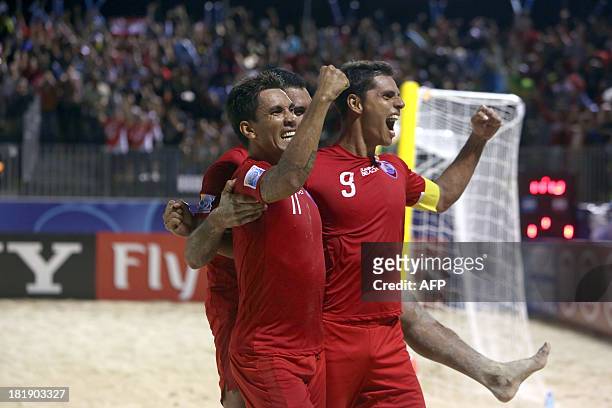 Tahiti players celebrate after scoring against Argentina on September 25, 2013 during a 2013 FIFA beach soccer World Cup quarter-final match in...