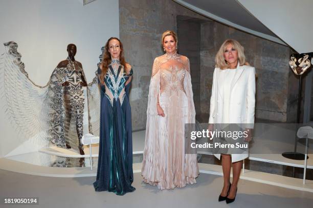 Iris van Herpen, Queen Maxima of the Netherlands and Brigitte Macron attend the "Iris van Herpen: Sculpting the Senses" Exhibition at Musee Des Arts...