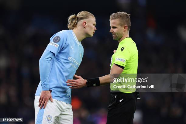 Referee Glenn Nyberg speaks with Erling Haaland of Manchester City during the UEFA Champions League match between Manchester City and Rb Leipzig at...