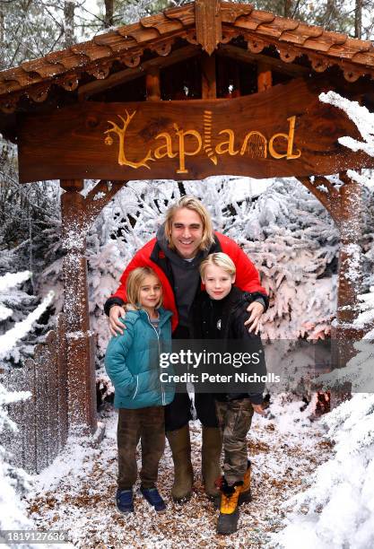 Charlie Simpson and his children Jago and Arlo pose for a photograph during their visit to LaplandUK at Whitmoor Forest on December 3, 2023 in...