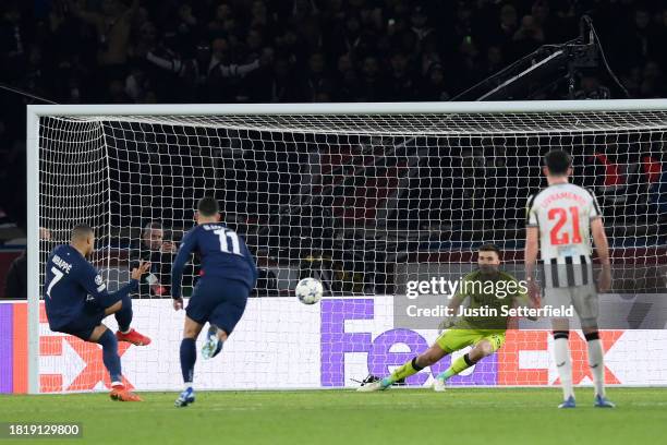 Kylian Mbappe of Paris Saint-Germain scores the team's first goal from a penalty kick during the UEFA Champions League match between Paris...