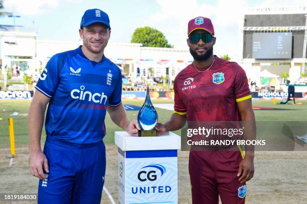 Jos Buttler , of England, and Shai Hope , of West Indies, stand with the series trophy during the first one day international cricket match between...