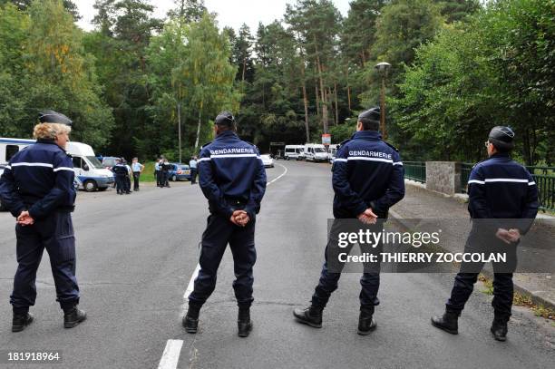 French gendarmes block a road on September 26, 2013 at the edge of a forest at Aydat Lake near the central French city of Clermont-Ferrand as...