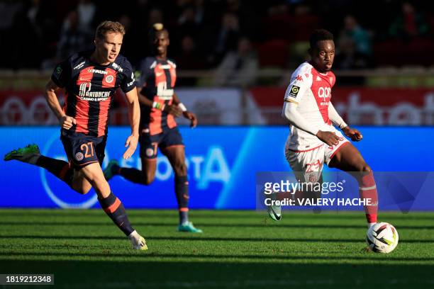 Monaco's US forward Folarin Balogun fights for the ball with Montpellier's Swiss defender Becir Omeragic during the French L1 football match between...