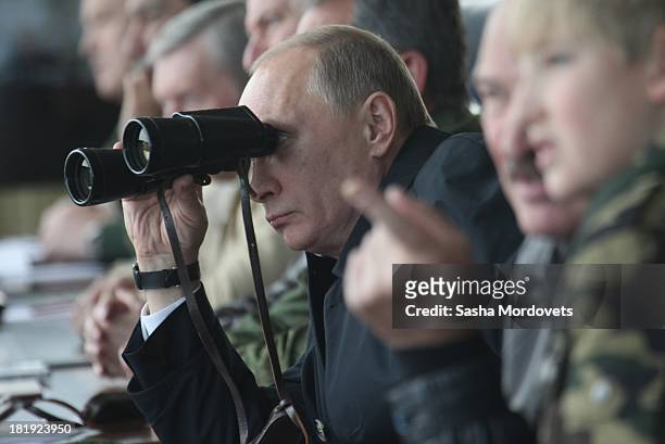 Russian President Vladimir Putin and Belarussian President Alexander Lukashenko watch joint Russian-Belarussian military exercises at the polygon on...