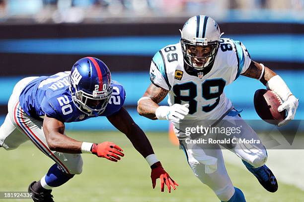 Wide receiver Steve Smith of the Carolina Panthers carries the ball and breaks away from cornerback Prince Amukamara of the New York Giants during a...