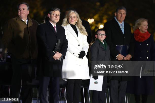Speaker of the House Mike Johnson , his wife Kelly Johnson, Ethan Reese, Sen. Joe Manchin and Sen. Shelley Moore Capito attend the lighting of the...