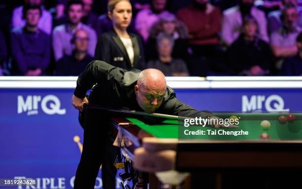 John Higgins of Scotland plays a shot in the first round match against Joe O'Connor of England on day 4 of the 2023 MrQ UK Championship at Barbican...